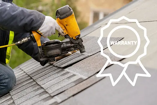worker using nailer to nail down shingles for roofing warranty blog